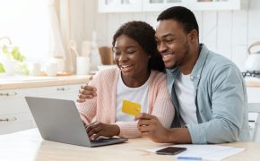 online-payment-black-spouses-with-laptop-and-credit-card-in-kitchen.jpg